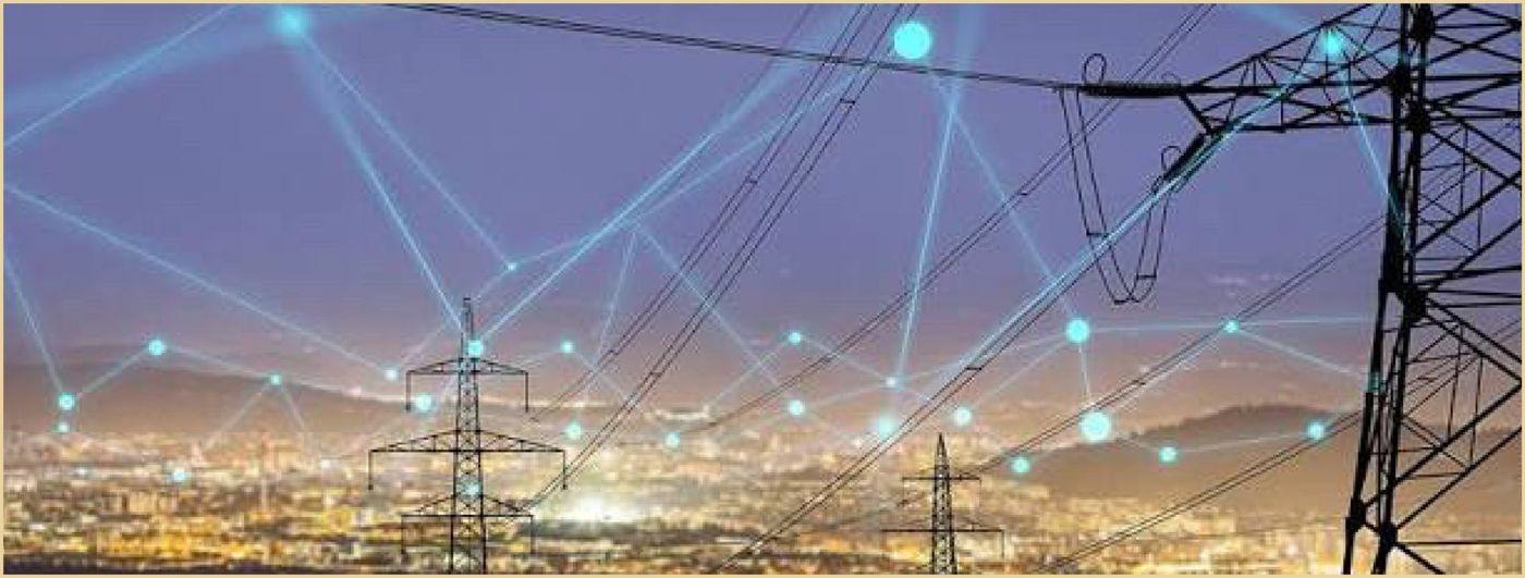 High-voltage transmission lines over a city at dusk