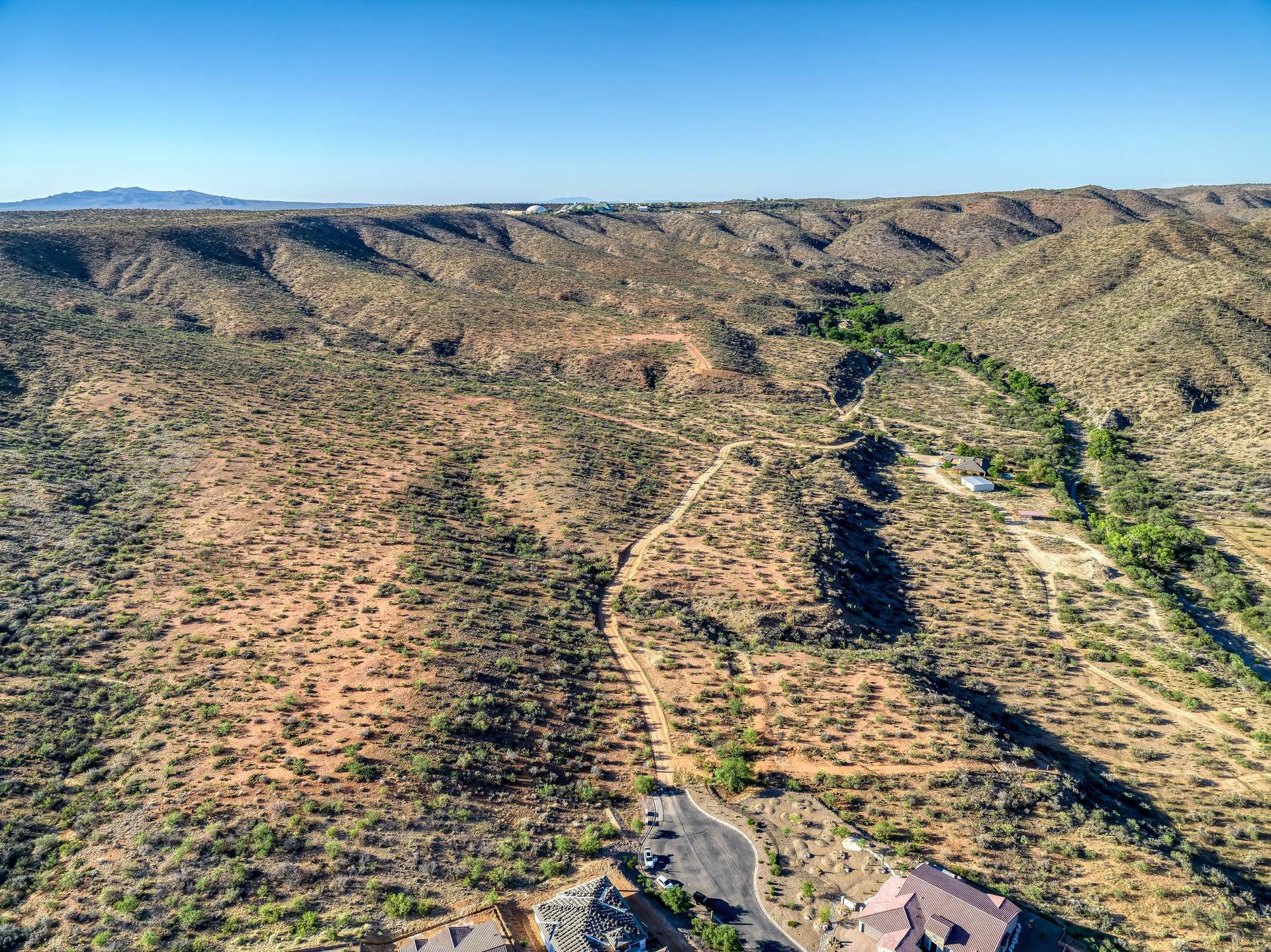 Aerial view of the desert wash and green corridor running through the site