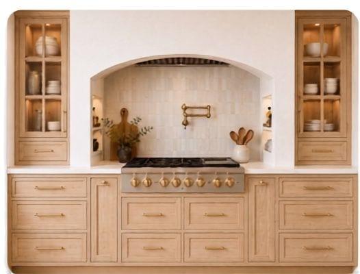 Inset cabinetry with arched hood and glass tower cabinets