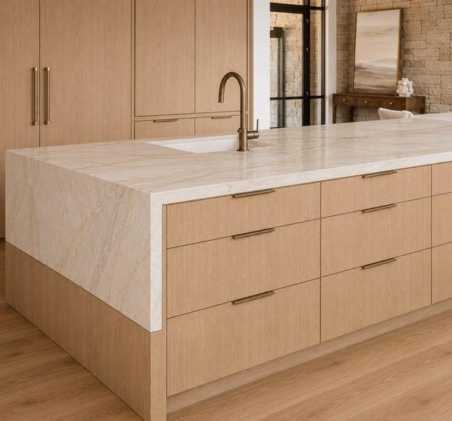 Waterfall stone island with white oak cabinetry