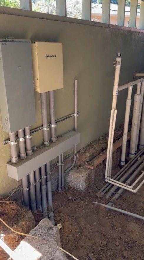 Pentair water treatment equipment with electrical panel and PVC plumbing manifold
