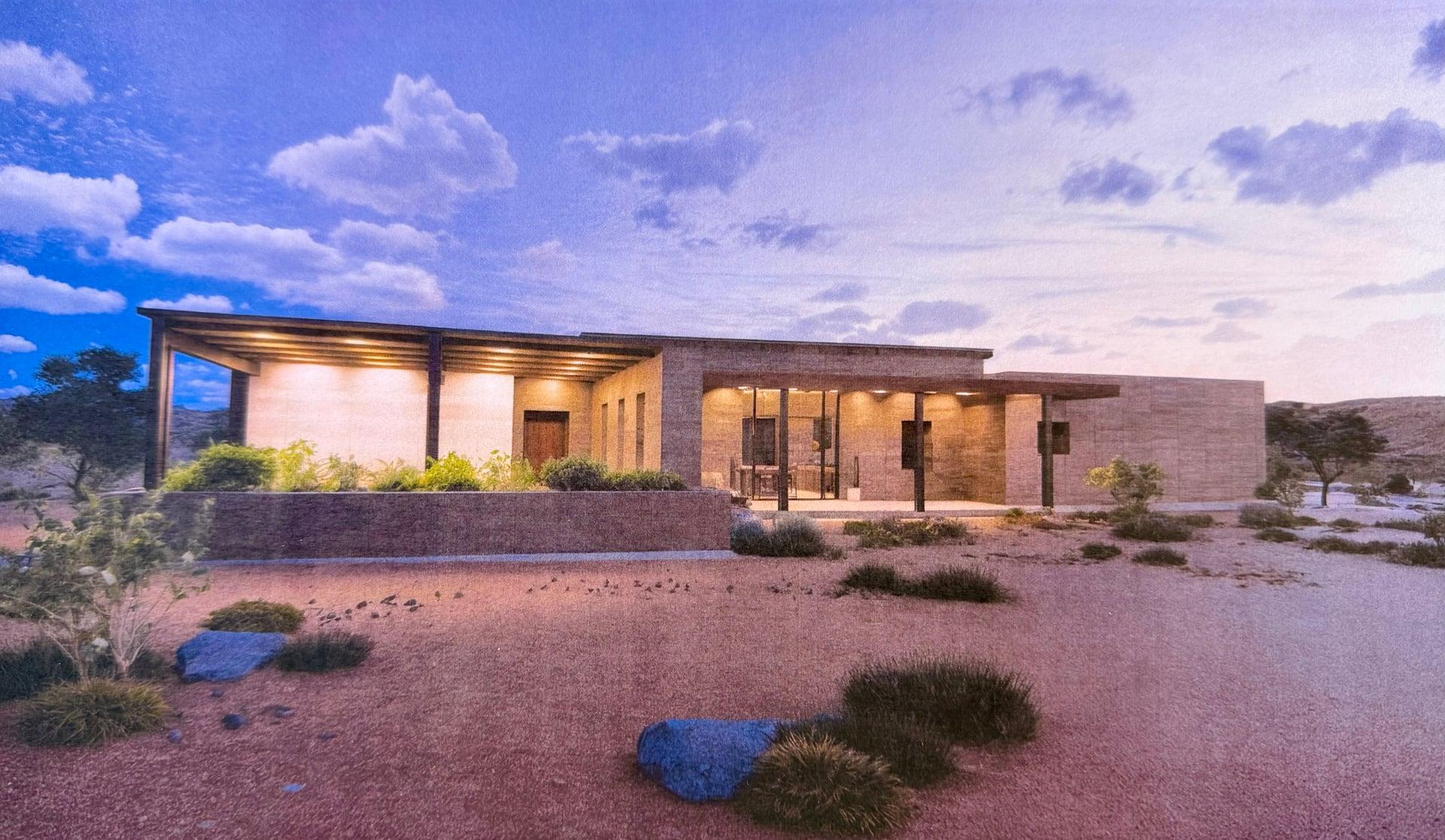 Design rendering of the rammed earth home at dusk with covered patios lit from within