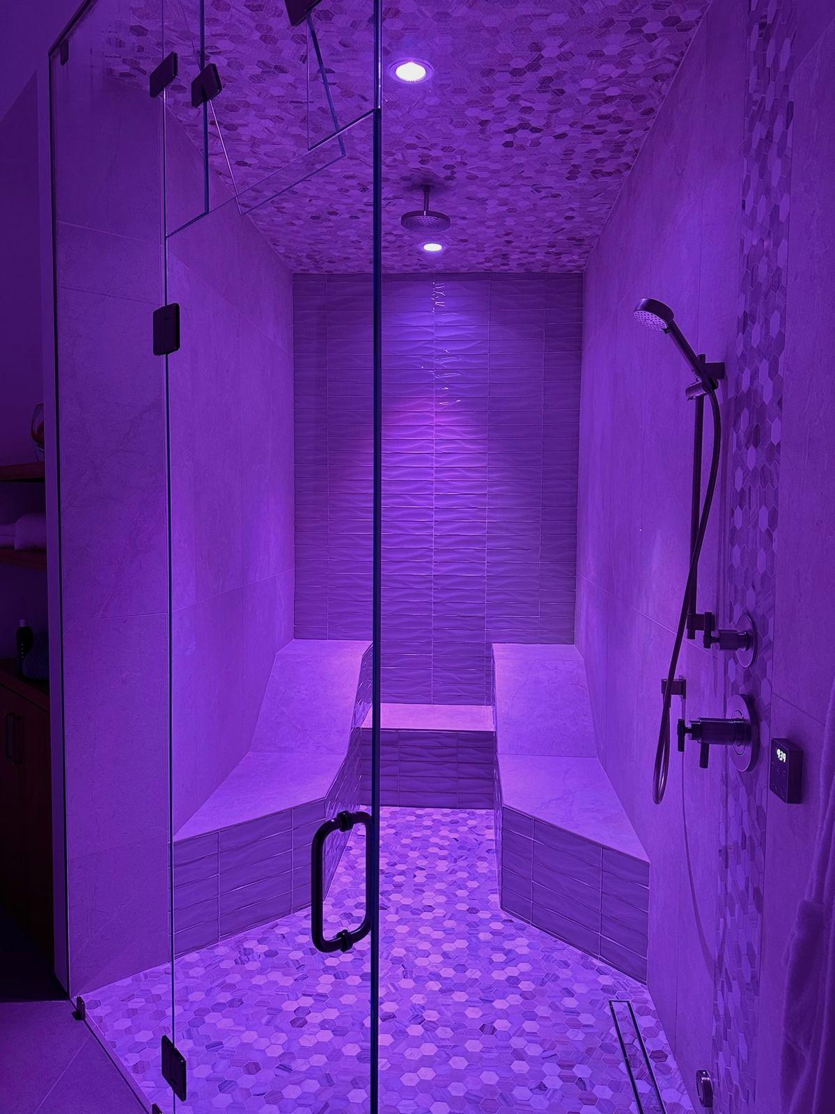 Steam shower lit in violet light
