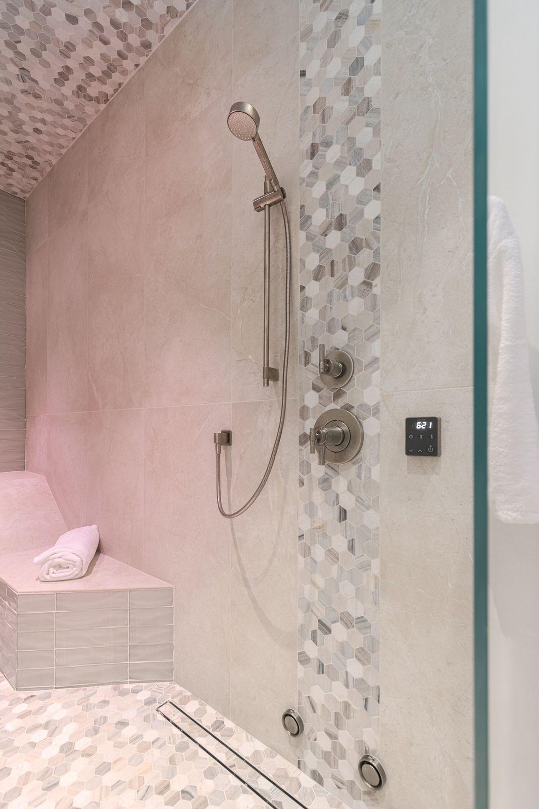 Steam shower with a tiled bench and handheld shower