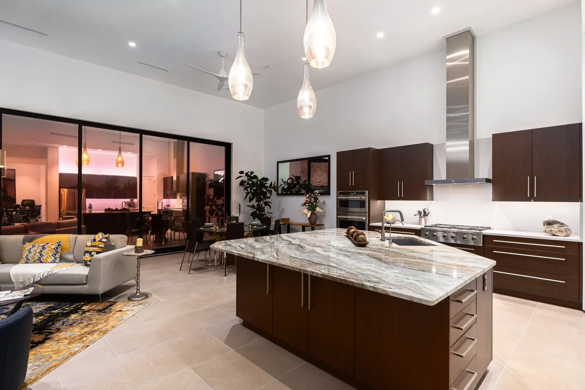 Open kitchen and great room with stone-top island and pendant lighting