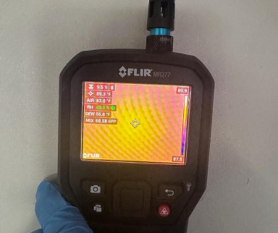 FLIR thermal imaging moisture meter scanning an interior wall