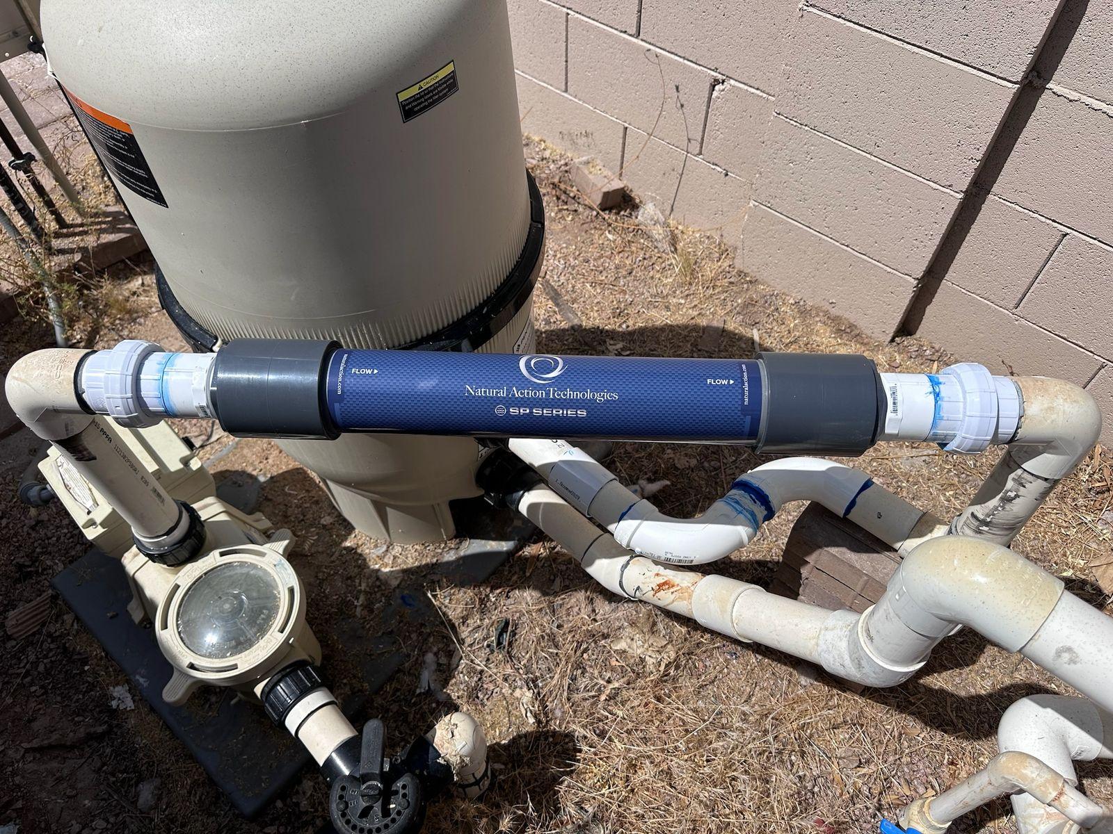 Natural Action inline structured water unit plumbed into the pool line beside the filter