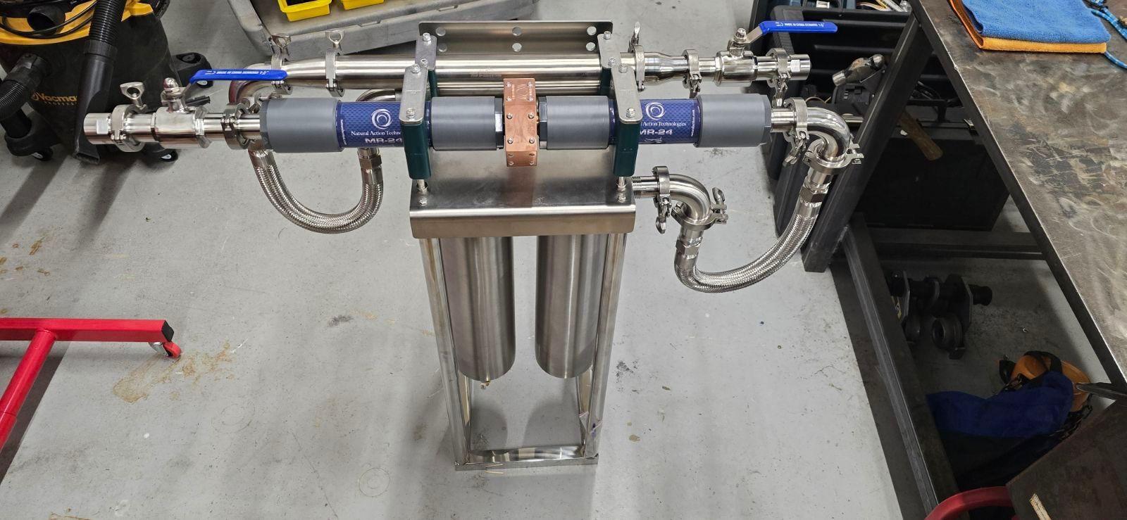 Stainless pool water assembly with inline units on a shop floor