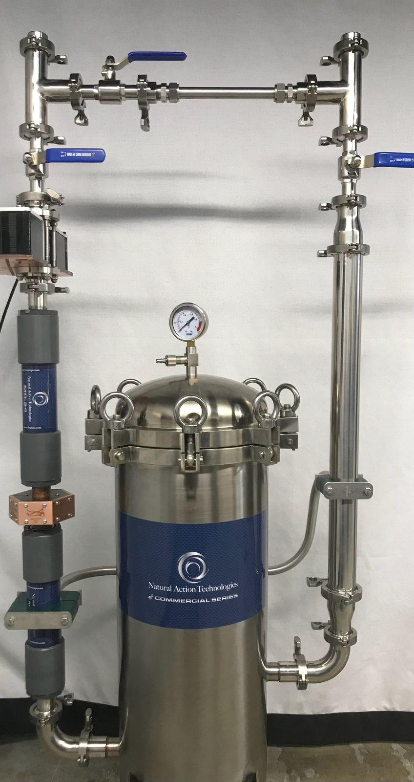 Stainless filter vessel with a pressure gauge, inline structured water units, and stainless piping on a shop frame
