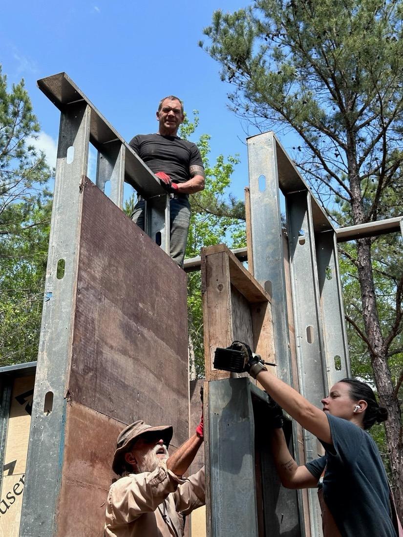 SENERGY360 founder Brian Johnson standing on top of a steel-framed wall during construction of a healthy home