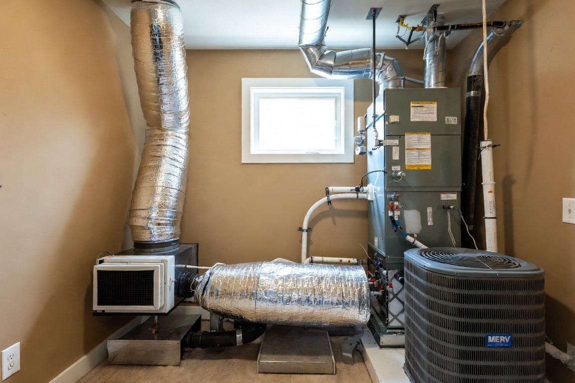 Clean residential mechanical room with an energy recovery ventilator and filtered air handler