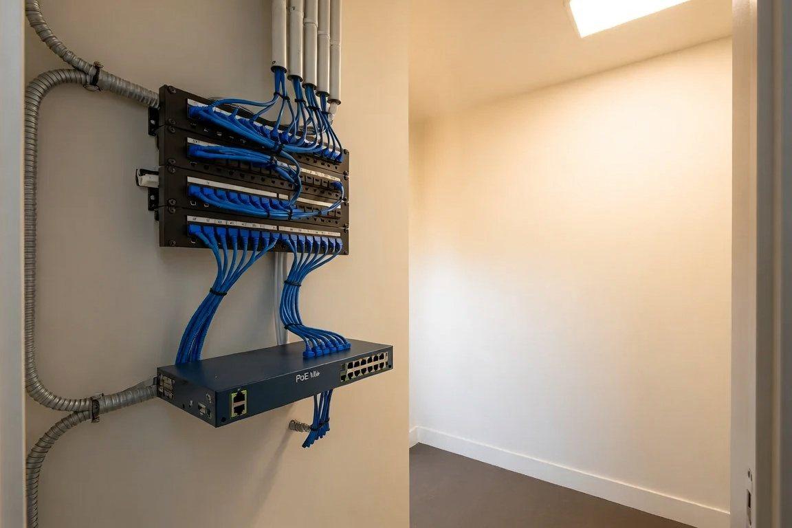 Residential structured-wiring closet with a labeled patch panel and network switch