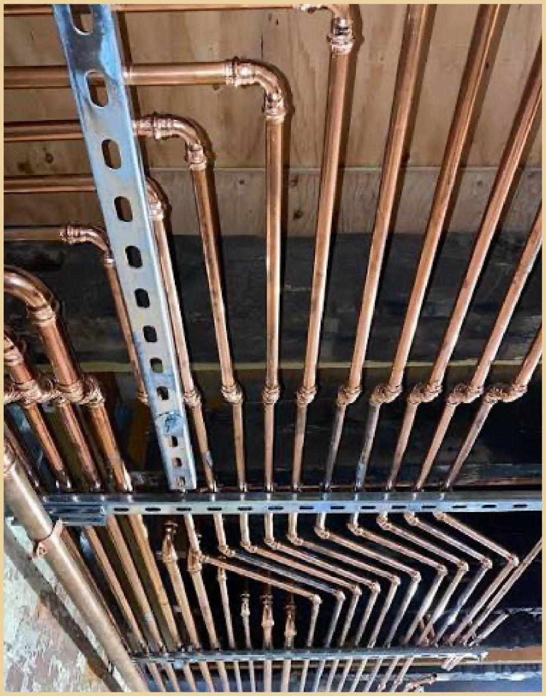 Copper supply lines run on a labeled manifold board