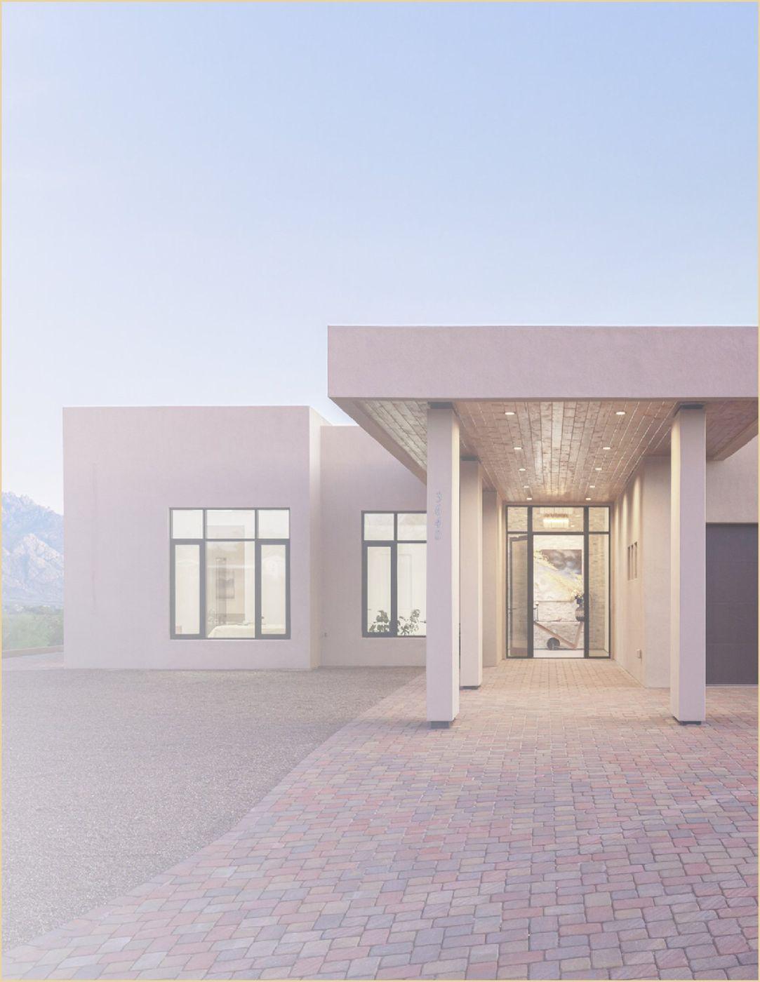 Rendering of a modern desert home with a covered entry and stone courtyard