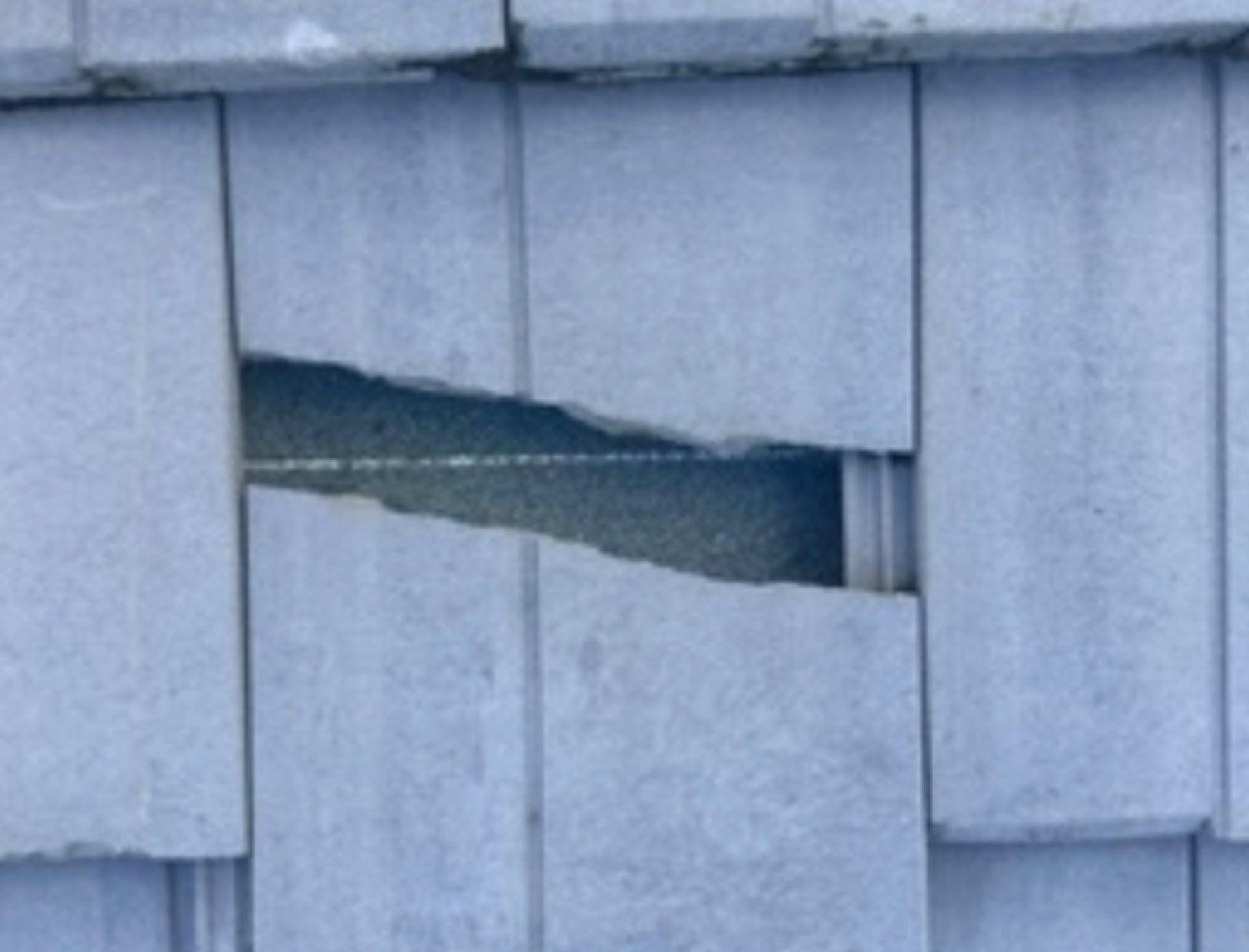 Cracked and displaced roof tiles