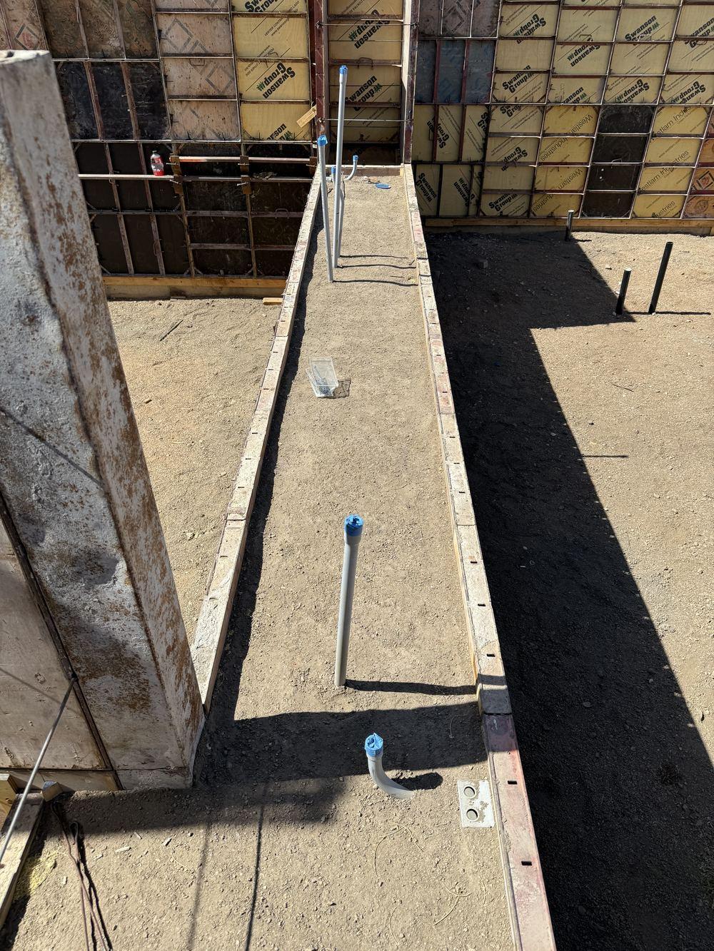 Footing trench with vertical rebar and formwork starter panels