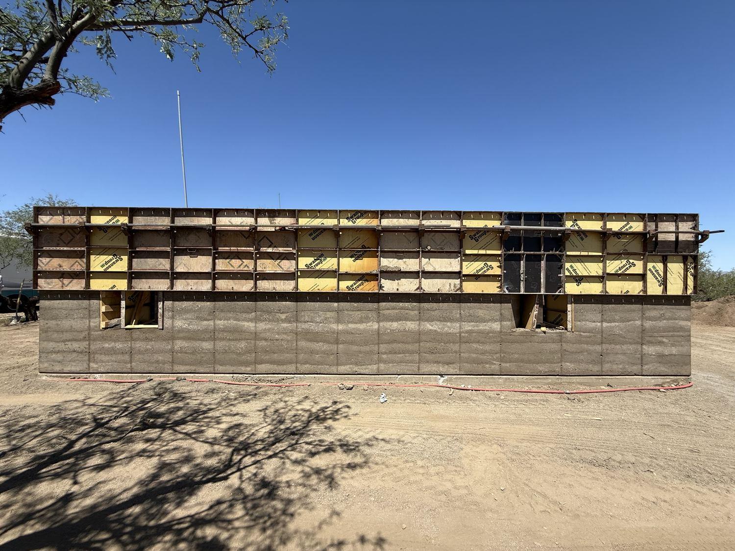 Full elevation of assembled formwork panels along the length of the house