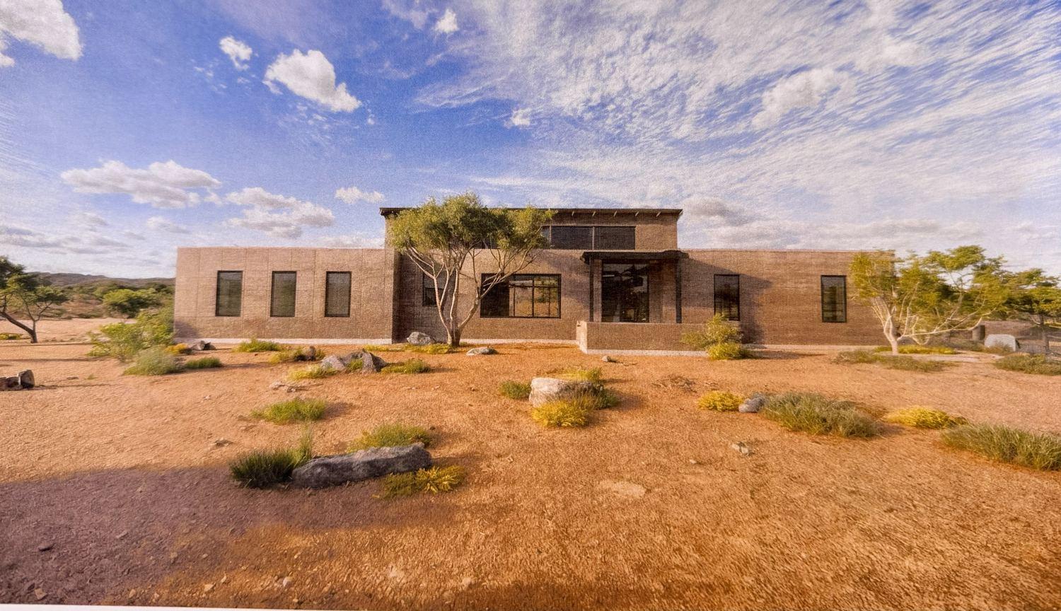 Rendering of the finished Chris Way residence, low rammed-earth volumes in the desert