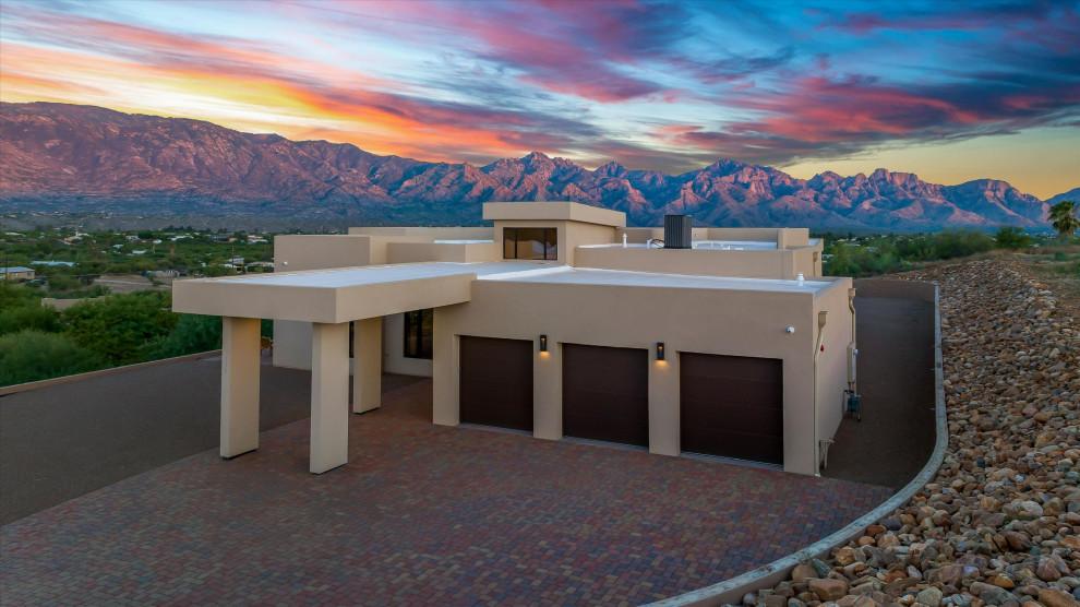 Aerial view of the Sanctuary House on its terraced hill at sunset, Santa Catalina Mountains behind
