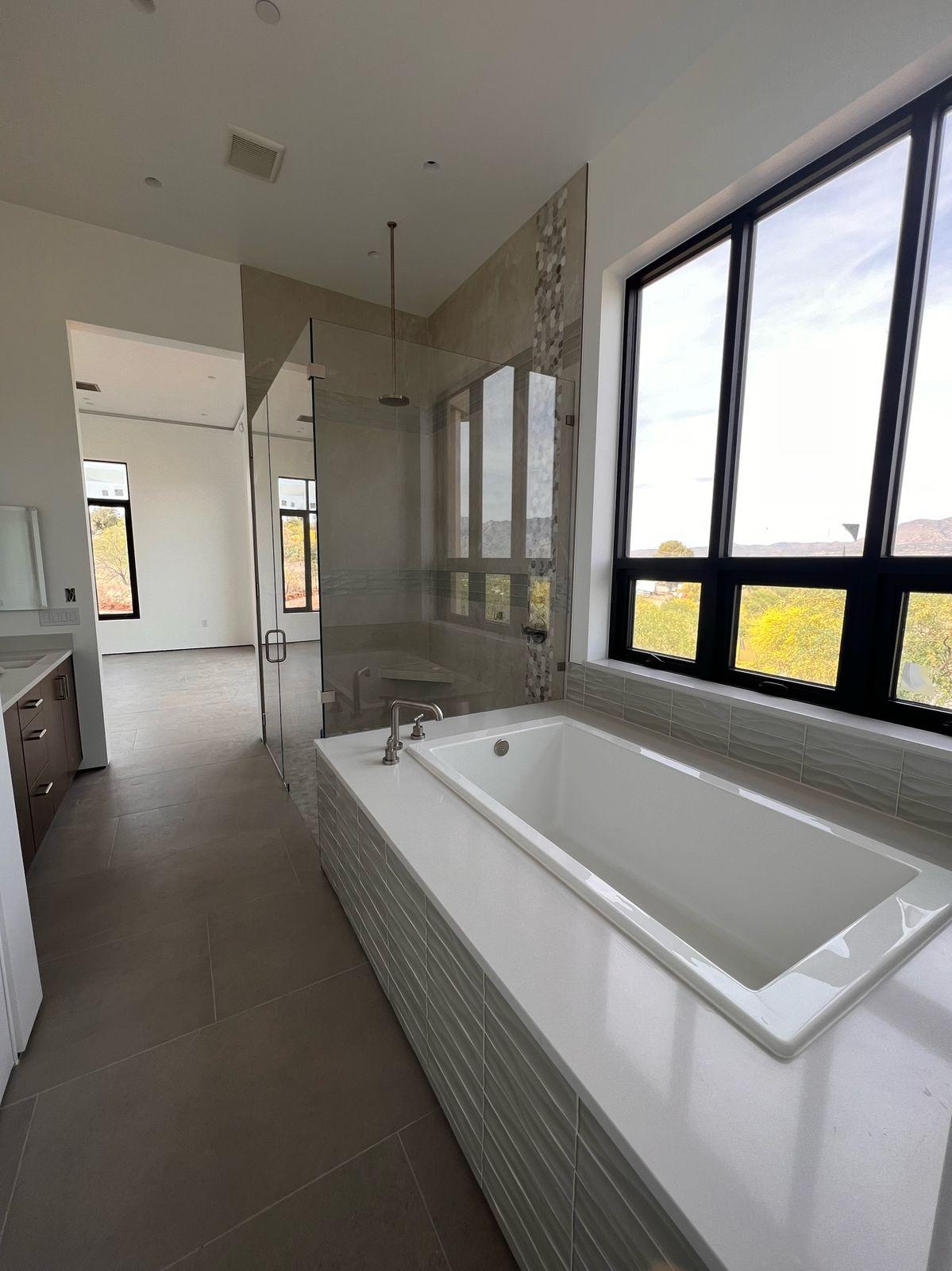 Soaking tub under a wall of windows