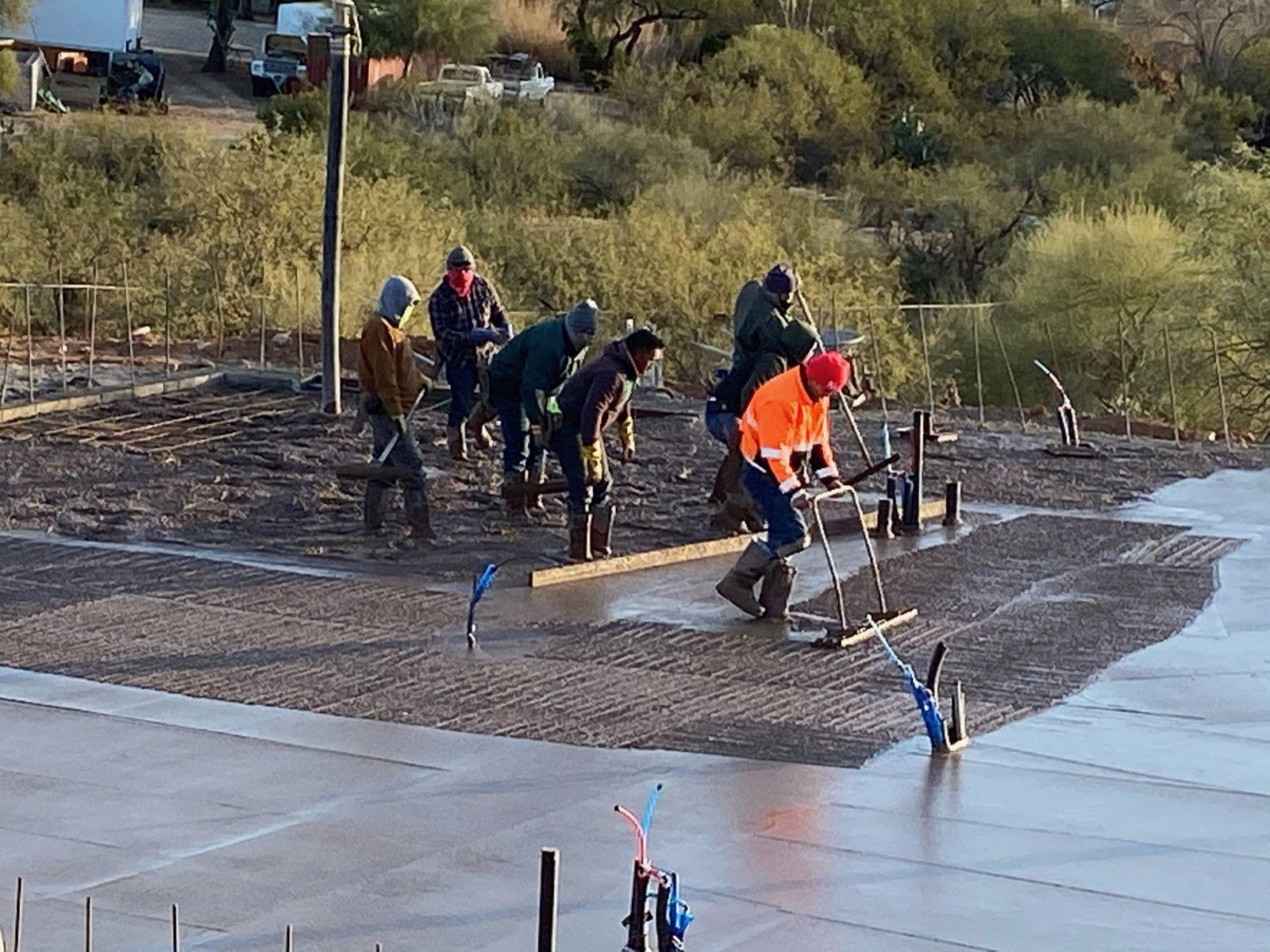 Crew screeding the wet slab
