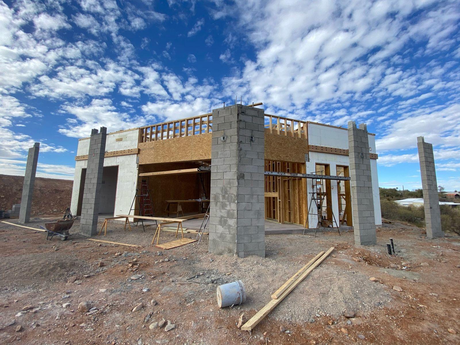 Exterior with entry columns and roof framing