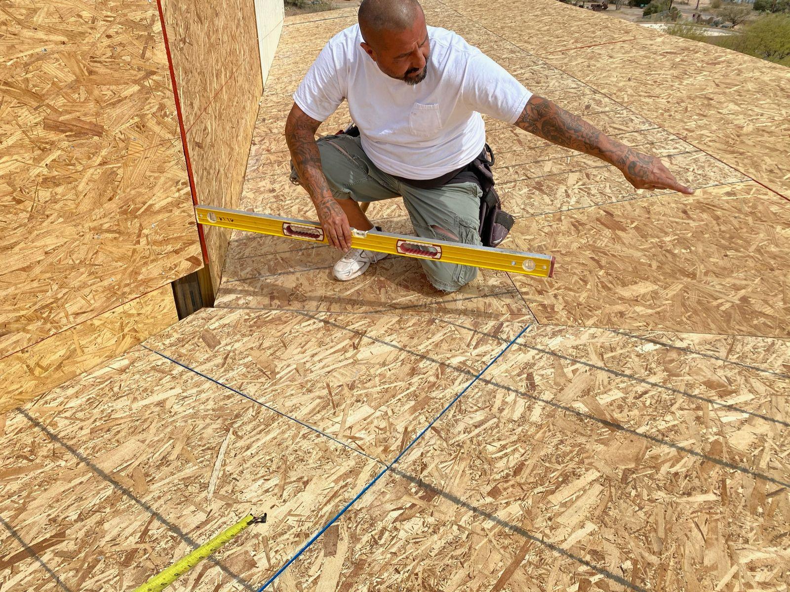 Crew member working on the roof sheathing