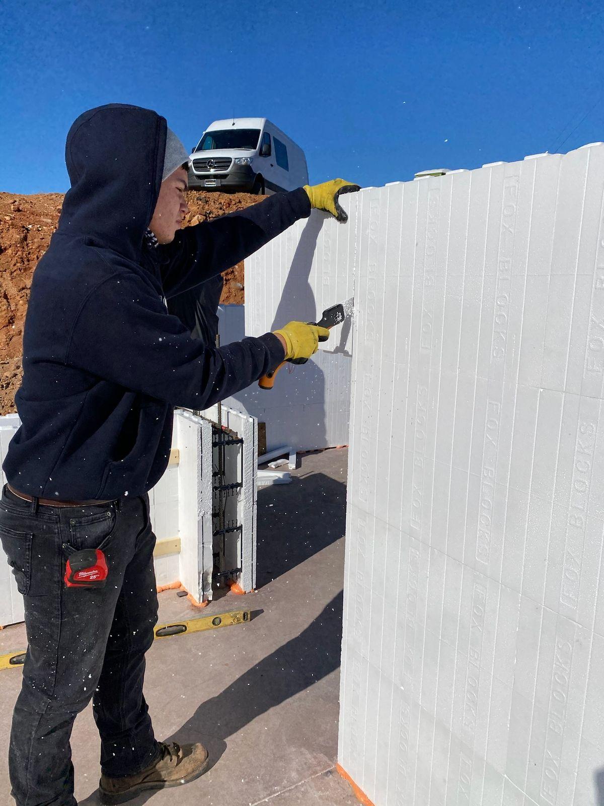 Crew member stacking ICF blocks
