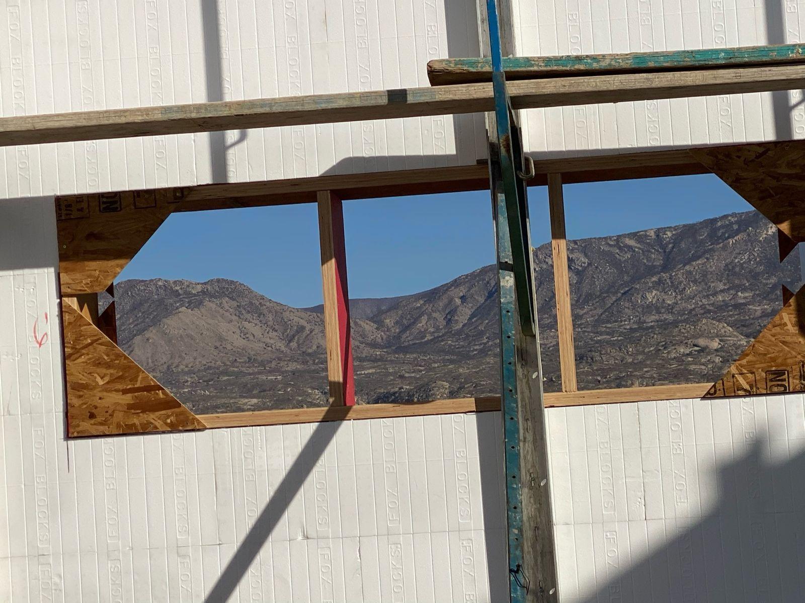 Window opening in an ICF wall framing the mountains