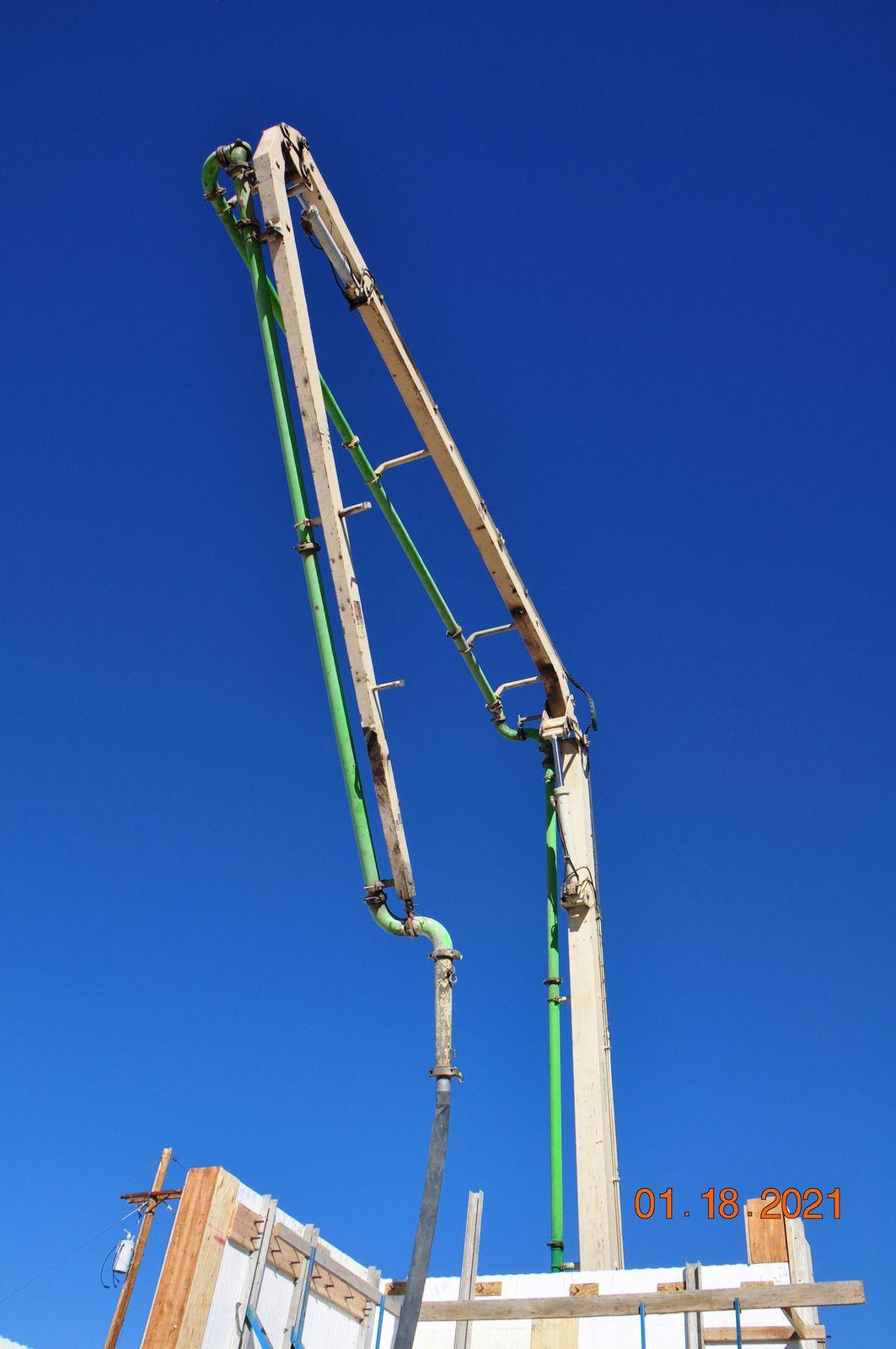 Concrete pump boom over the walls