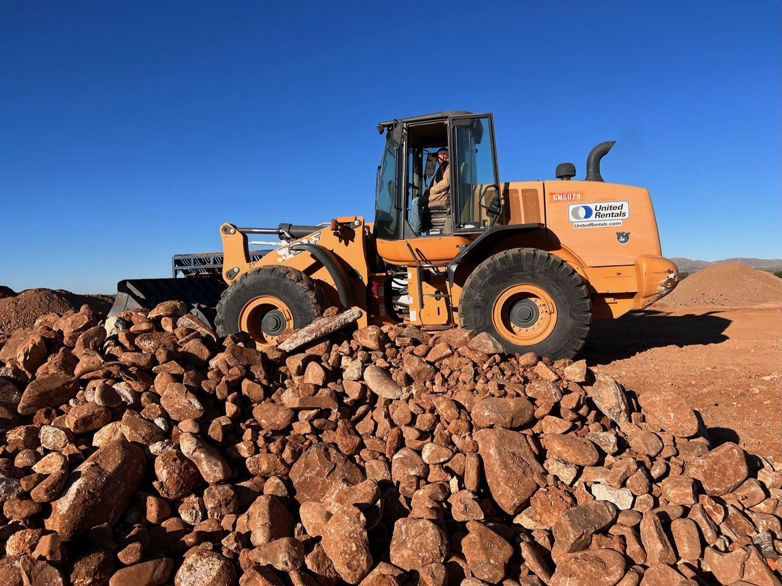 Loader moving rock on site