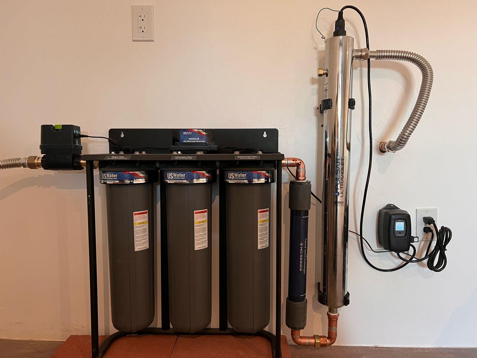 Three-stage water filtration with UV treatment on the wall
