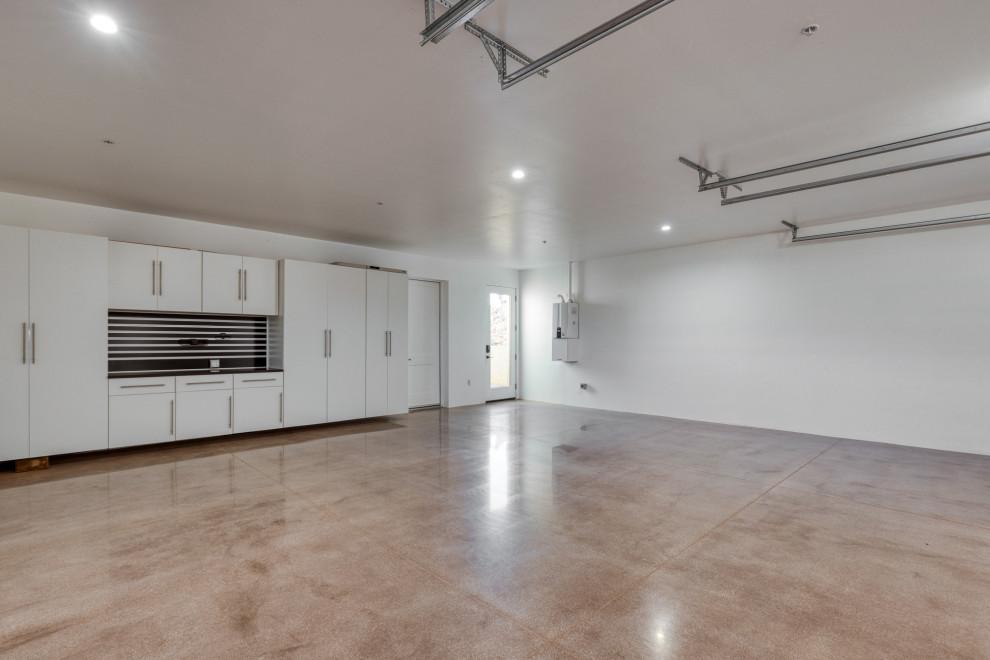 Finished garage with polished concrete floor and white wall cabinets