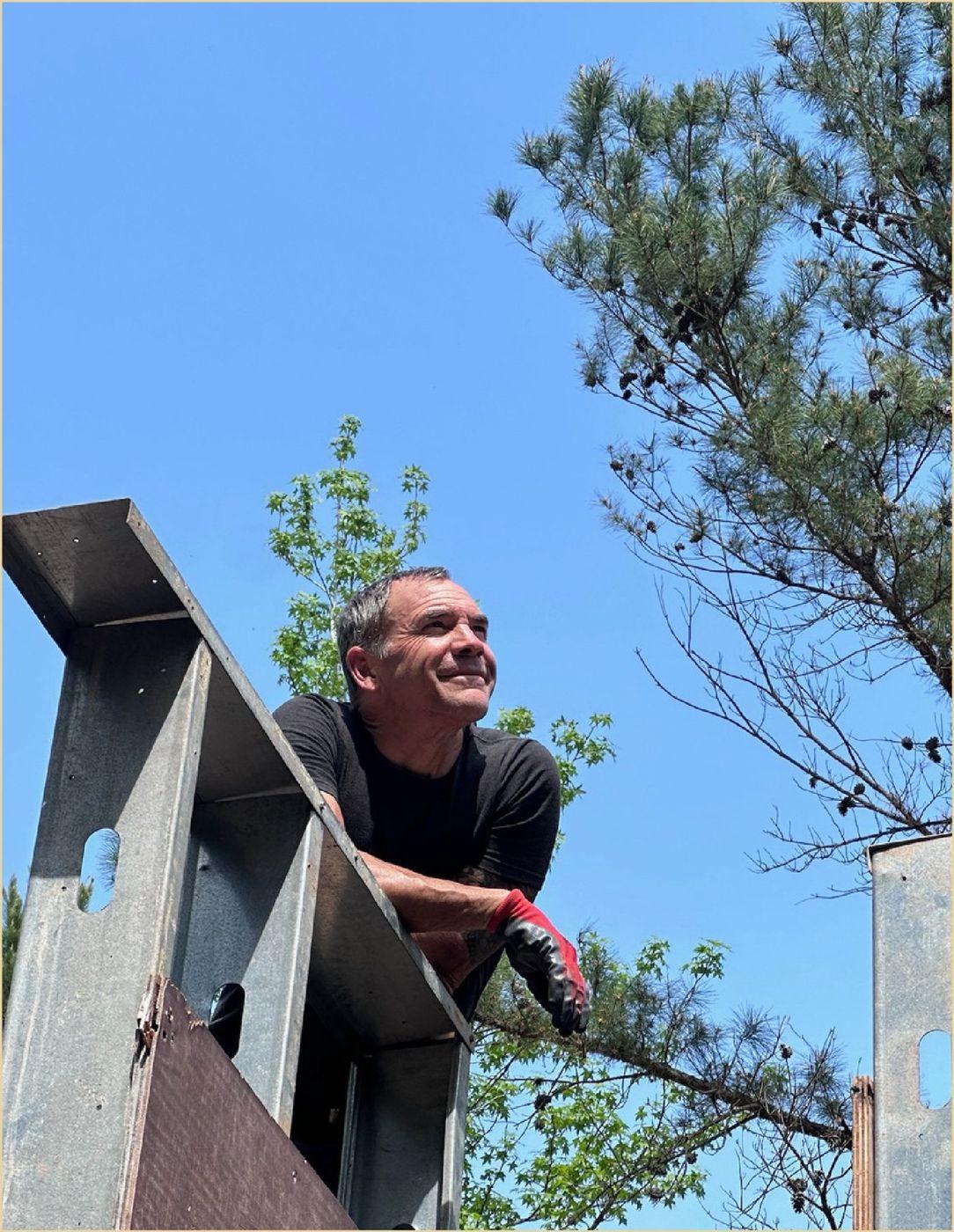 Brian Johnson leaning over the top of a formwork wall on a jobsite