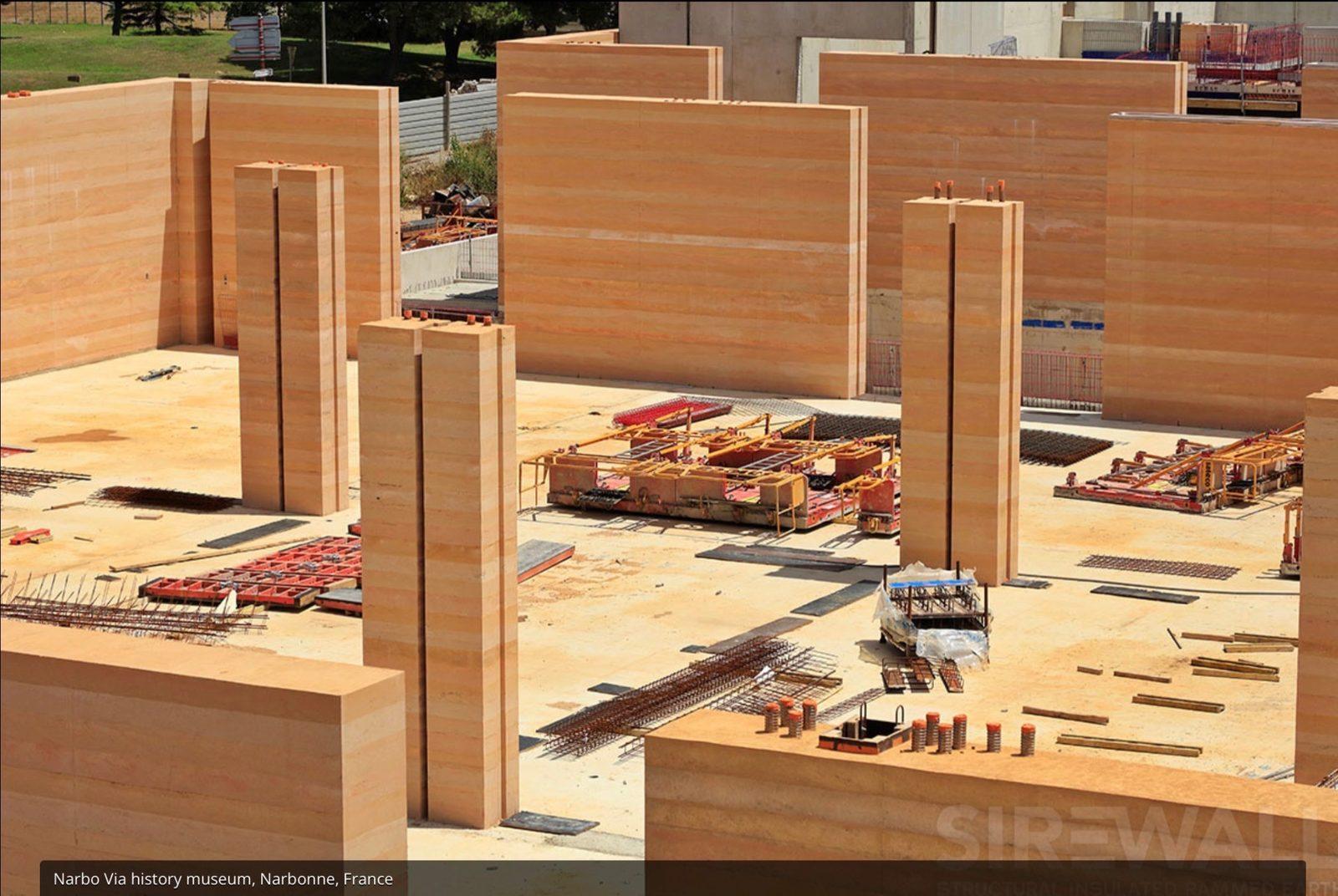 Rammed earth wall panels and formwork at a SIREWALL training site