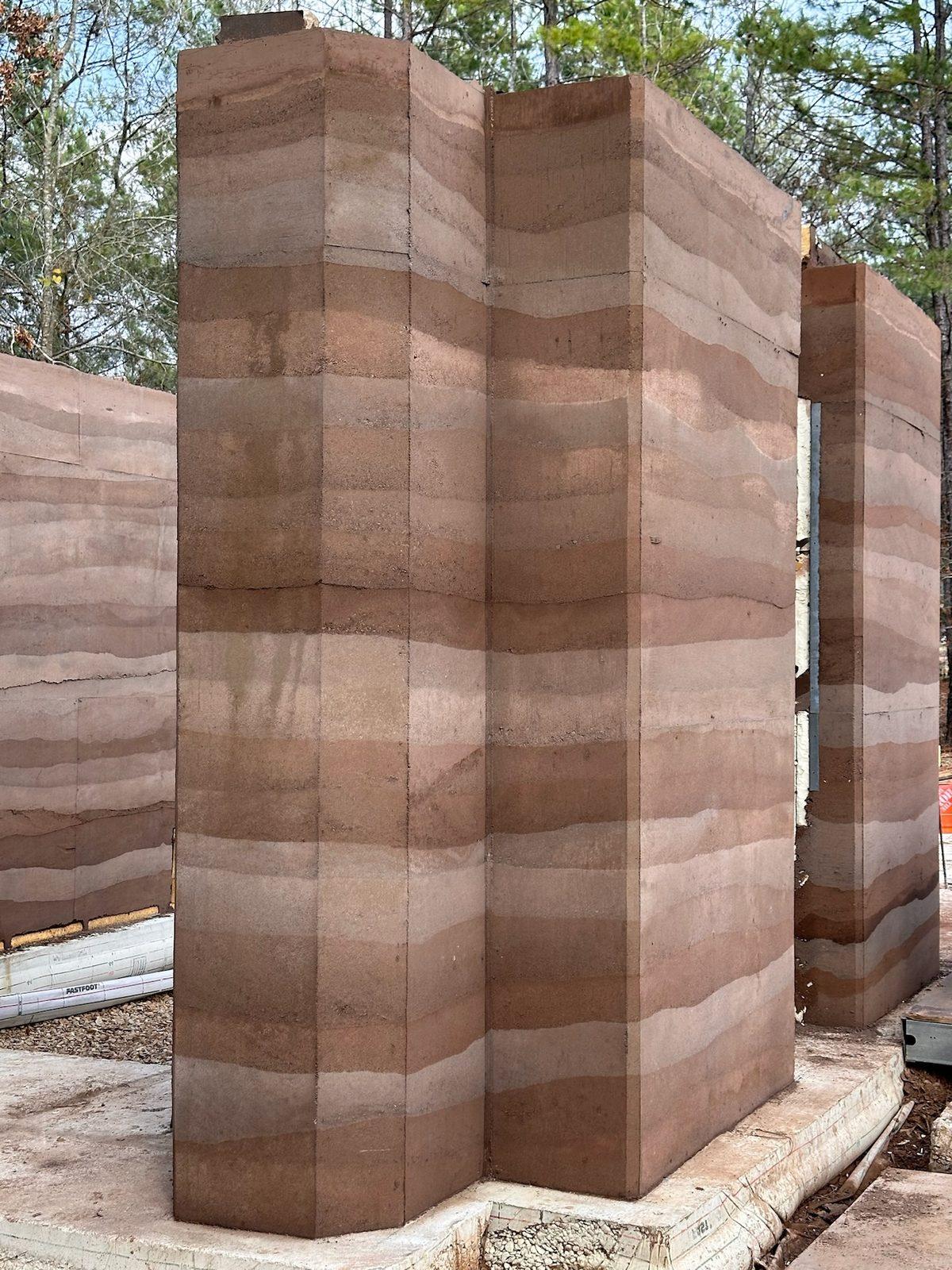 Group of rammed earth wall panels at the training site