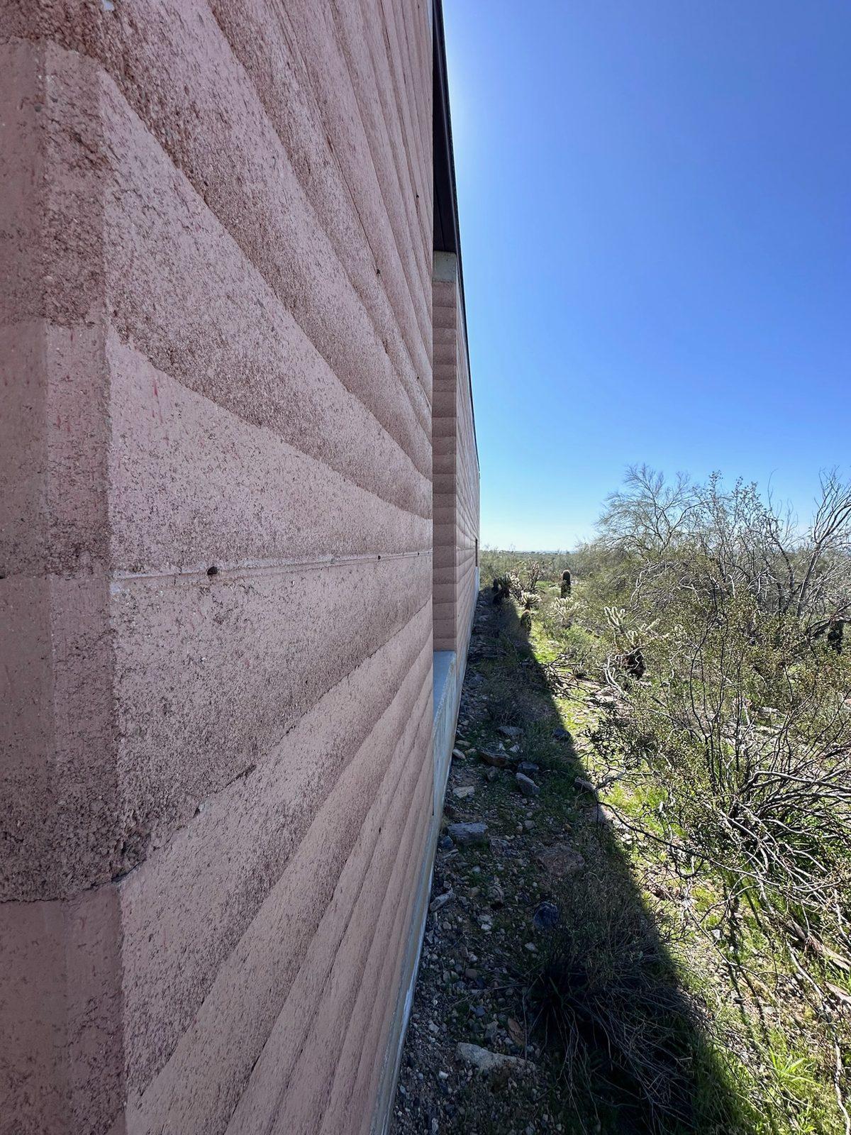 Close view along a rammed earth wall face