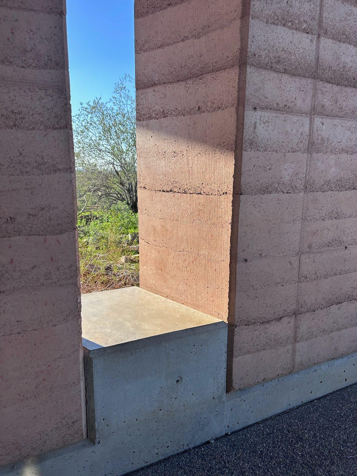Narrow gap between two rammed earth walls