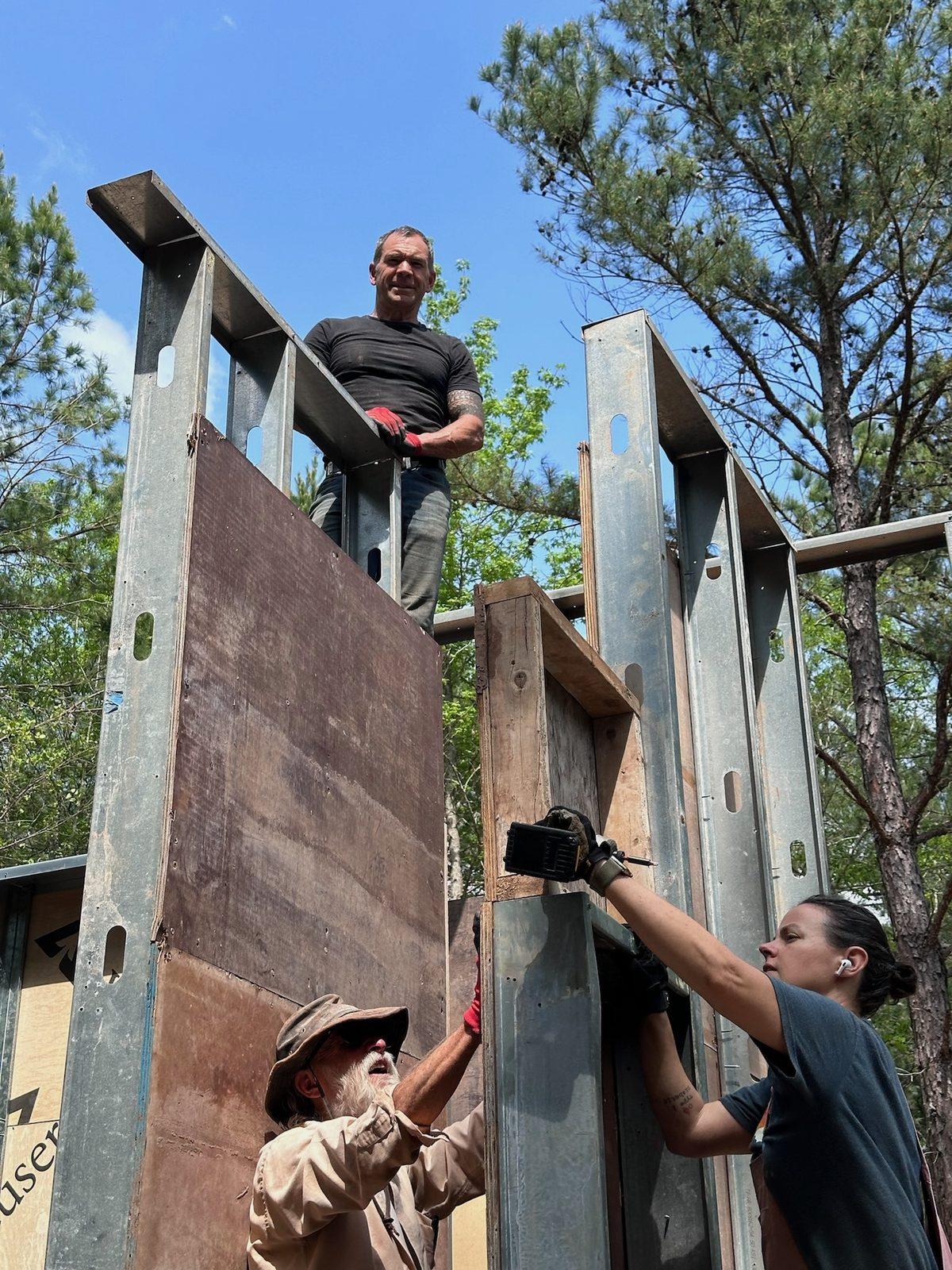 Brian Johnson on top of the steel-braced forms with the crew